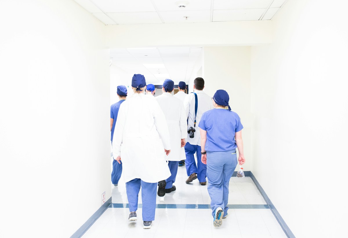 Healthcare staff in a hospital hallway A medical team walking through a private hospital corridor, the sector now inside Emiratisation quotas